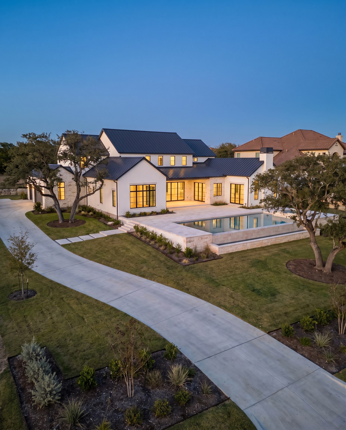 A newly completed luxury home marketed for sale, seen from a drone.